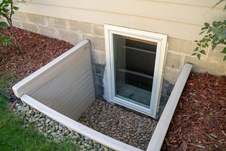 Large egress window providing emergency exit and abundant natural light in a basement space